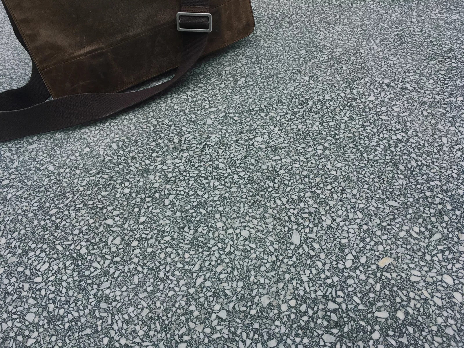 Terrazzoplatte fugenlos grün mit Tasche darauf